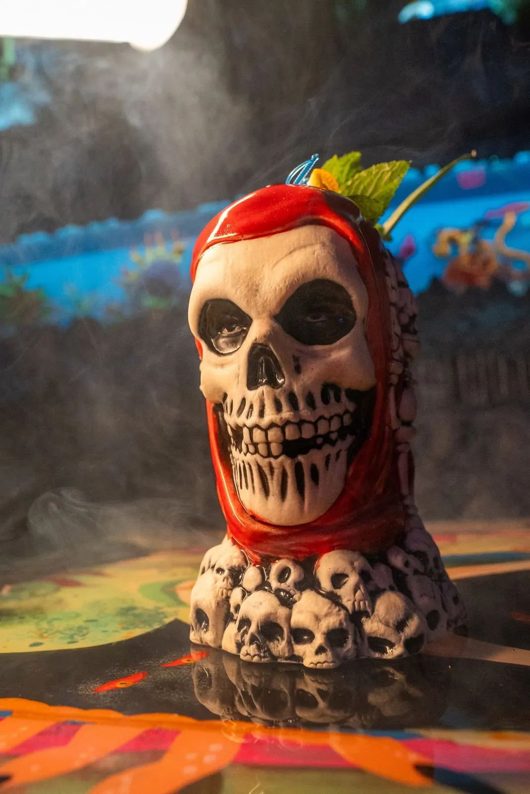 The red-hooded skull tiki mug in smoke